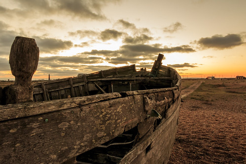 dungeness kent shingle pebble beach wooden fishing boat wreck sunset sun set