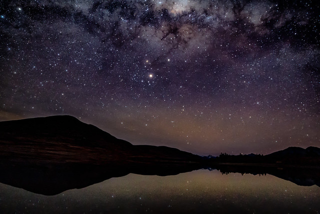 Lake Camp mountain silhouette and milky way reflections