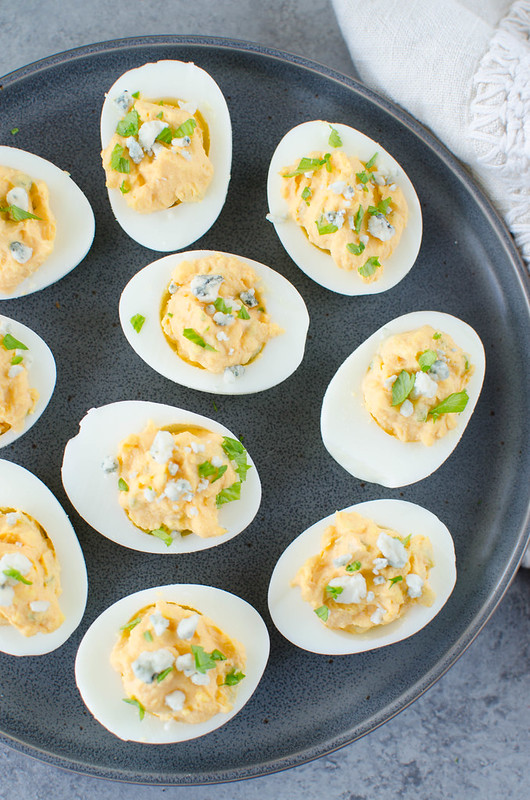 Buffalo Deviled Eggs - spicy buffalo deviled eggs topped with blue cheese. Perfect for a party!