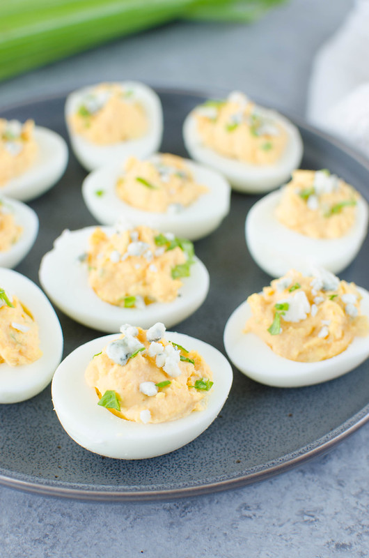 Buffalo Deviled Eggs - spicy buffalo deviled eggs topped with blue cheese. Perfect for a party!