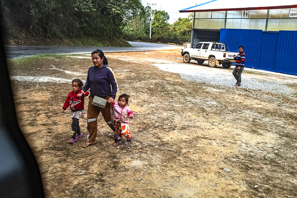 A woman and two girls about to board a minibus--Phieng Luang