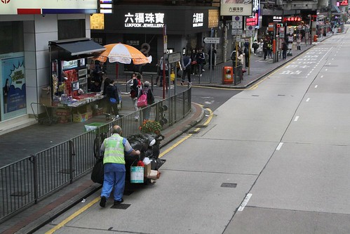 Pushing a trolley loaded with rubbish down Nathan Road