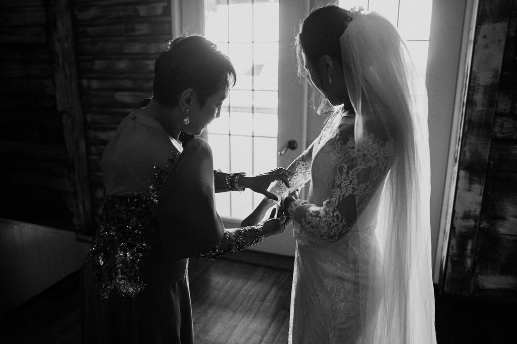 Mom Helping Bride with the Wedding Dress
