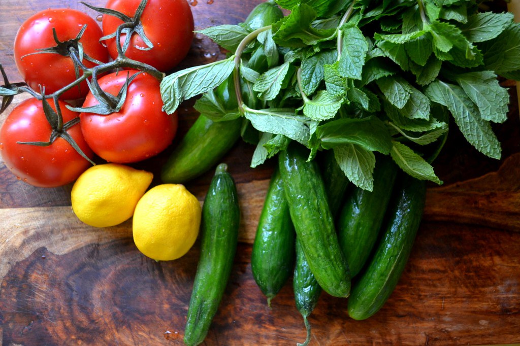 The base of a classic Israeli Chopped Salad, crispy cucumbers, sweet tomatoes, fresh lemon and lots of fresh herbs.