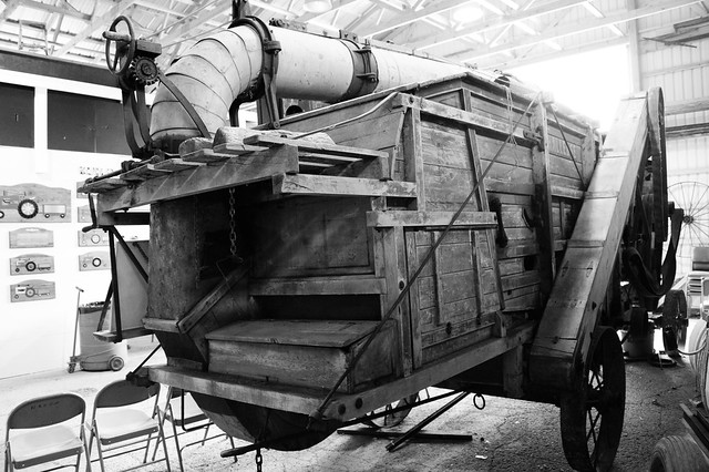 Wooden thresher , found at out door display at a farm machinery collection , seen at doors open 2014 in Port Hope , Martin’s photographs , photograph converted to black and white , Port Hope , Ontario , Canada , June 8. 2014