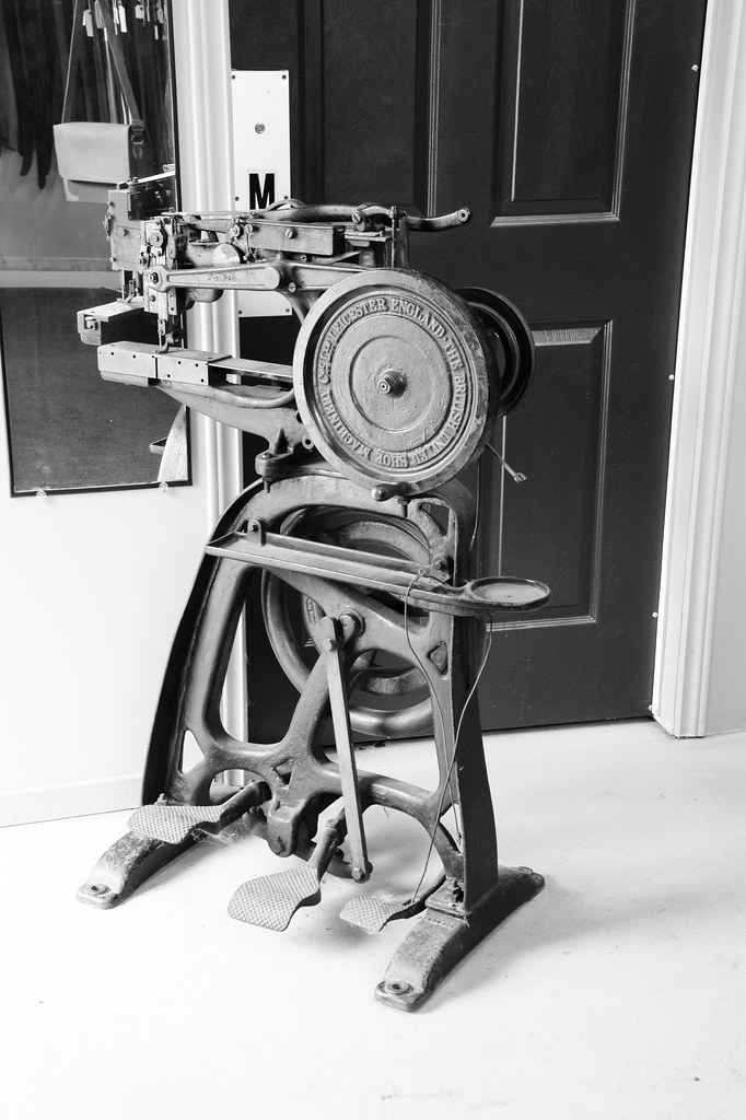 Leather sowing machine run manually by foot paddles , from the British united shoe co. Ltd Leicester England machinery or other companies , found In leather shop , Doors Open , Martin’s photograph , photograph converted to black & white , Port Hope , 2014