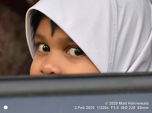 matthahnewaldphotography facingtheworld head eyes childreneyes nose expression lookingatcamera hijab parentalconsent diversity humanity travel transport lifestyle happiness upbringing childhood traffic ethnic local traditional cultural muslim islam islamicclothing roadside kuah langkawi malaysia malaysian malay asian asia human person one female child kid girl young little primelens nikond610 nikkorafs85mmf18g 85mm 4x3ratio resized 1200x900pixels horizontal street portrait closeup faceshot cropped twothirdview sidewaysglance outdoor naturallight colour cute authentic pretty peeking looking sweet lovely clarity