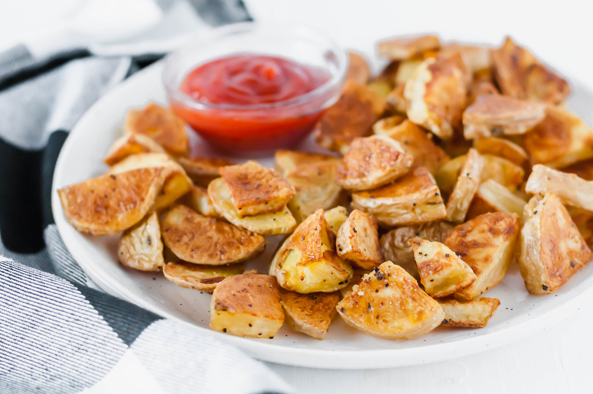 Learn how to make the crispiest potatoes around. These Crispy Roasted Potatoes are simple to make. The crispy exterior and tender, fluffy interior will blow your mind. Read the post for all the tips on making crispy roasted potatoes.