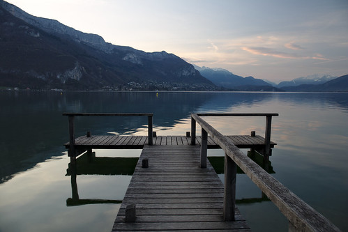 annecy france travel tourism water lake blue sunrise sun sky mountains alps pier reflection calm