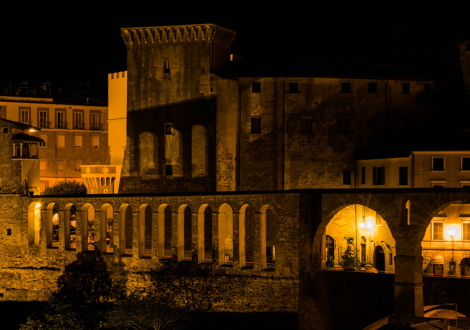 Acqueduct in Pitigliano at night, one of the best places to visit in Tuscany