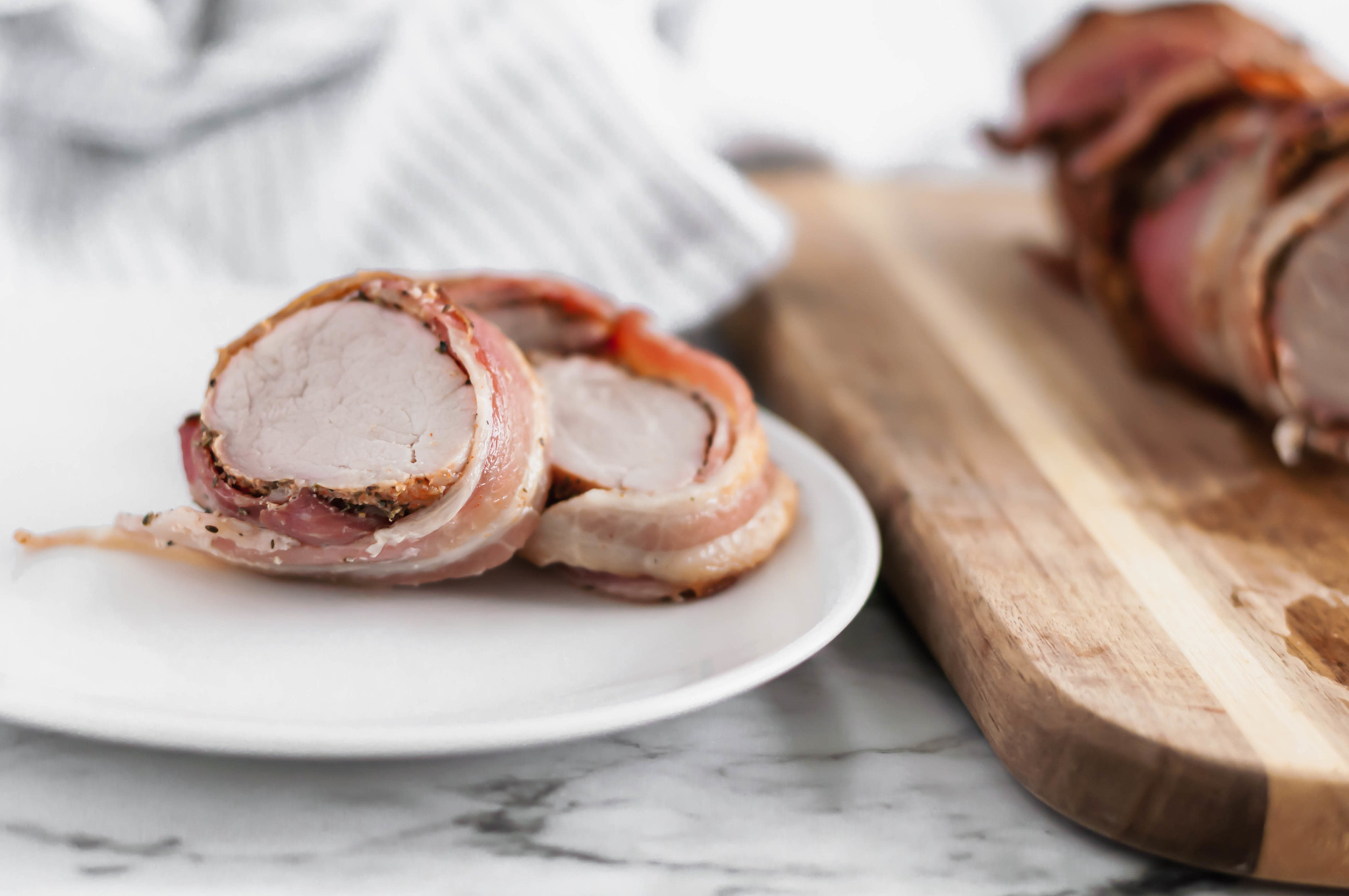 This Bacon Wrapped Pork Loin is fancy enough for guests but easy enough for weeknight meals. Packed with herbs and all the crispy bacon.