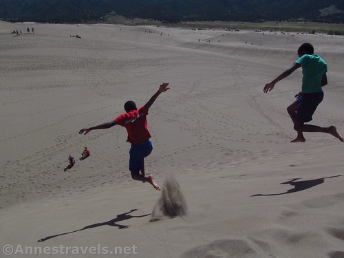 Jumping down one of the lower dunes, Great Sand Dunes National Park, Colorado