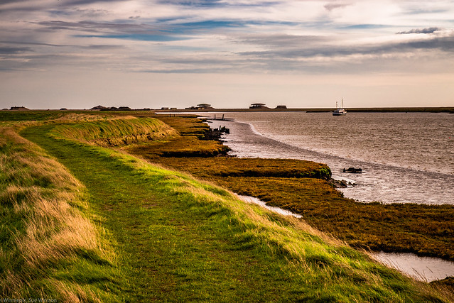 From the pathway along the River Alde looking towards Orford Ness, with the outline of the two former nuclear testing bunkers ('pagodas') on the horizon