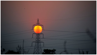 setting sun as observed between pylon wires