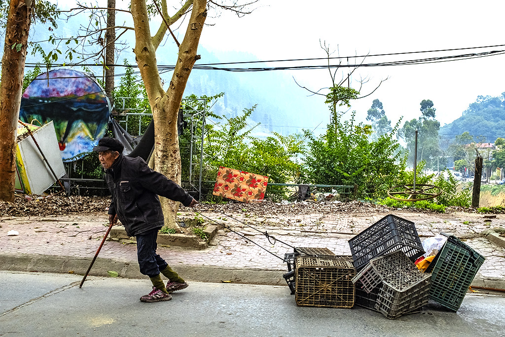 Old man with cane, pulling plastic crates--Si Ma Cai
