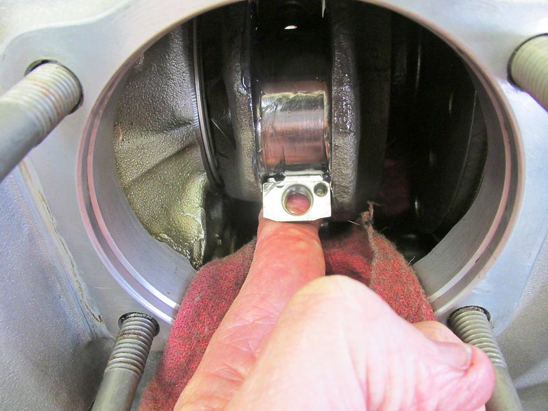 Right Side Rod End Cap Installed On Crankshaft Journal with One Finger