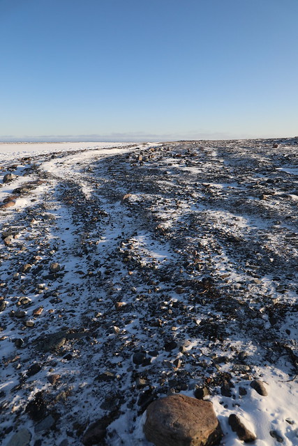 Arctic landscape with snow forming on the ground with rocks exposed