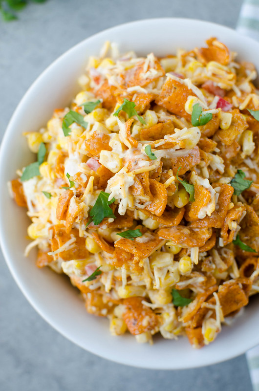 Fritos Corn Salad - crisp corn, bell pepper, cheese, and Chili Cheese Fritos in a creamy dressing. The perfect no cook, super easy summer side dish for all your barbecues!