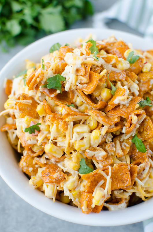 Fritos Corn Salad - crisp corn, bell pepper, cheese, and Chili Cheese Fritos in a creamy dressing. The perfect no cook, super easy summer side dish for all your barbecues!