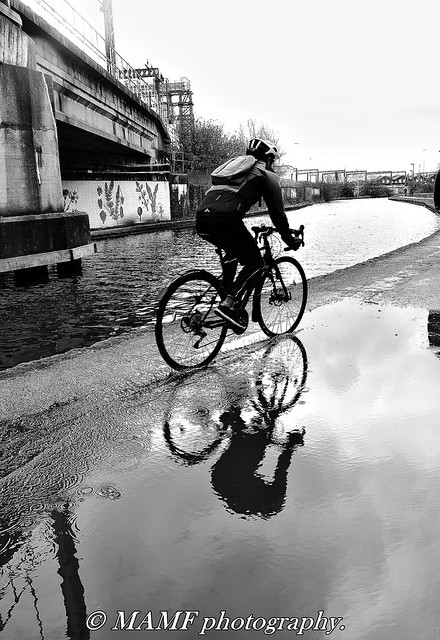 Reflection of cyclist by the Leeds - Liverpool canal.