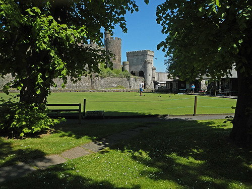 Conwy Castle with its towers and turrets looking across the lawn bowling court