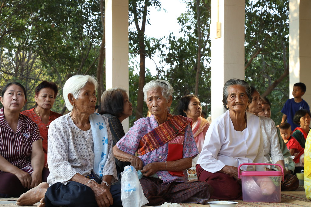 A picture of the participants at the rice festival. In front is three old women in traditional Isan garments.