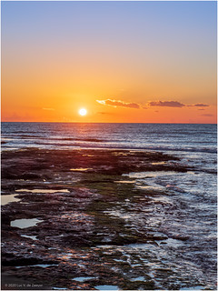Sunset seen from a rocky shore