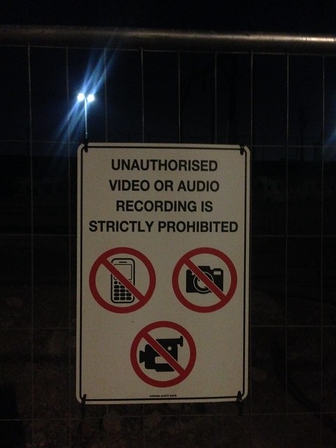 Photography prohibition signs on front of Melbourne Metro Tunnel construction site at Arden Station, North Melbourne