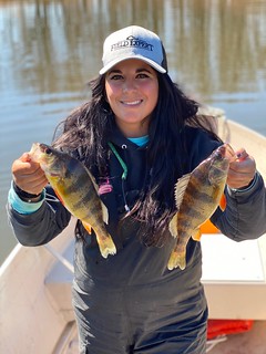Photo of woman holding two yellow perch