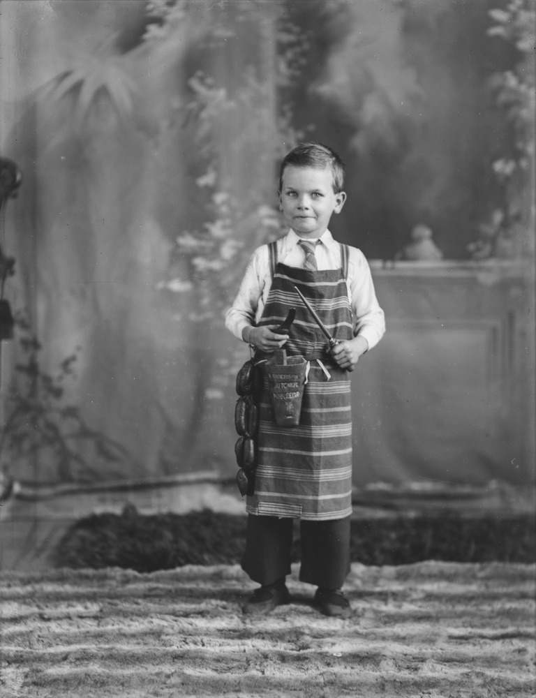 Studio portrait of a young boy dressed as a butcher in Mareeba Queensland