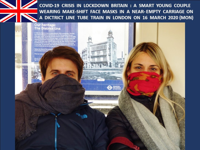 COVID-19 Crisis in Lockdown Britain - A smart couple wearing makeshift Face Masks in a near-empty District Line Tube Train in London on 16-MAR-2020