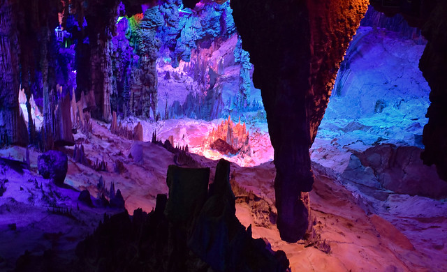 Reed Flute cave of Guilin, China, with beautiful and dramatic mineral rock formations with stalactites and stalagmites colored with artificial lighting