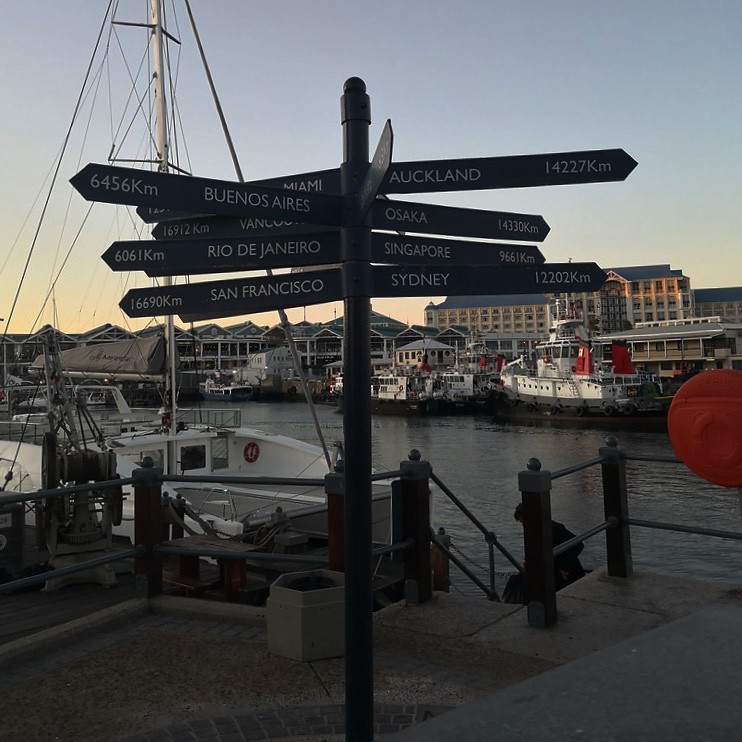 Road signs with distance to different cities in V&A Waterfront