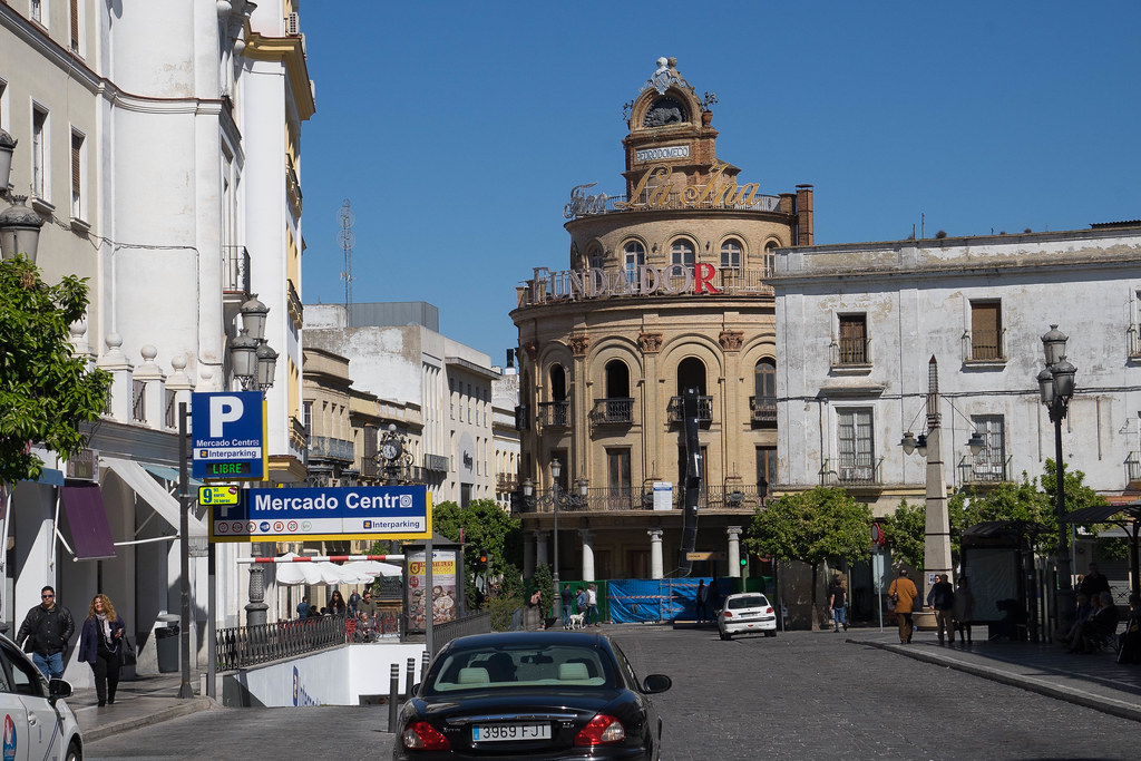 Driving on a street in Jerez de la Frontera. There is a black car in front.