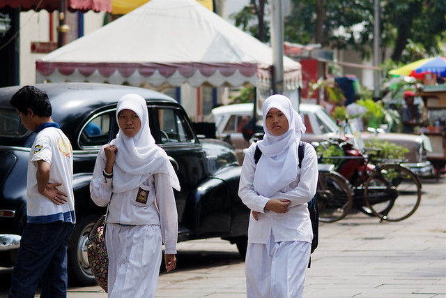 Veiled Indonesian muslim student girls with uniform in Batavia neighborood in Jakarta - Java, Indonesia