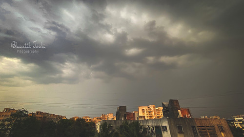earthpix mobilephotography shotoniphone india maharashtra pune evening ominous overcast clouds noperson nopeople urban buildings structure light sunset gray dark outdoors weather nature photography balcony sky