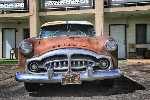 A rusty Packard in front of the motel