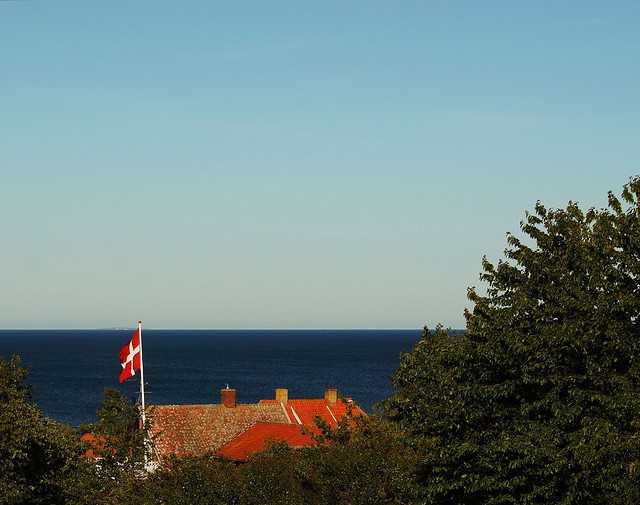 View of the Baltic Sea to the east above the Bornholm city of Allinge. Christiansø, the easternmost place in Denmark is seen on the horizon.