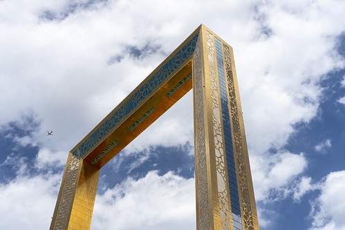 dubai frame gold blue sky plane airplane clouds white architecture emirates view look building art