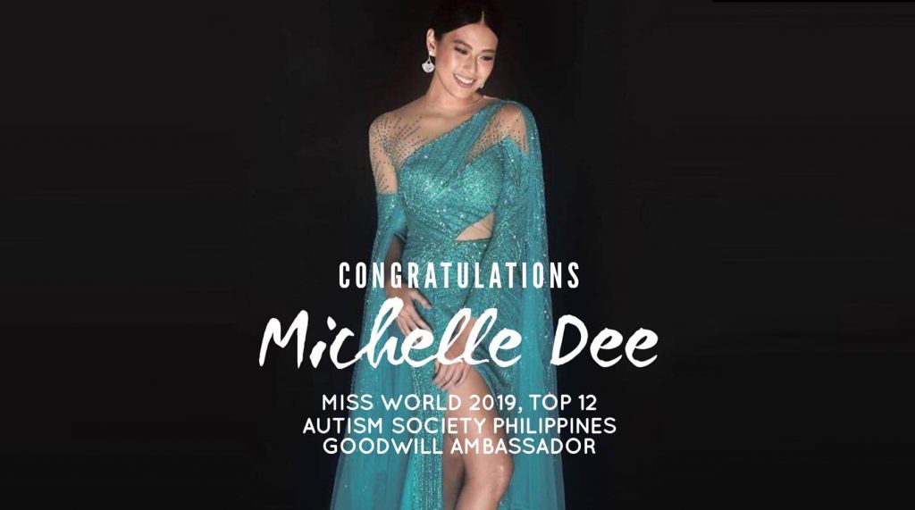 The image shows Ms. World Philippines Michelle Dee wearing her light blue dress and a fan like earrings with hair tied. The background is black.