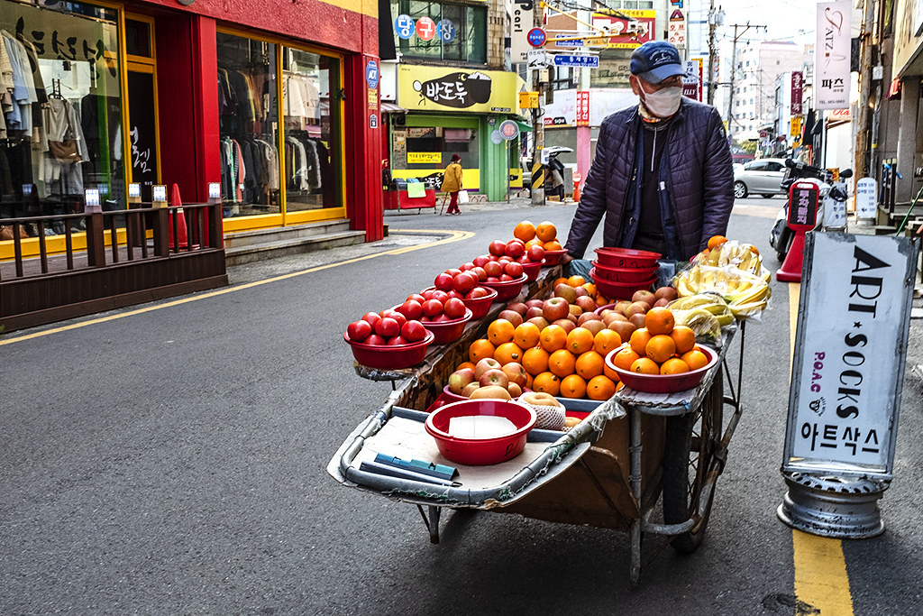 Man selling fruit from pushcart on Hero Street--Yeosu