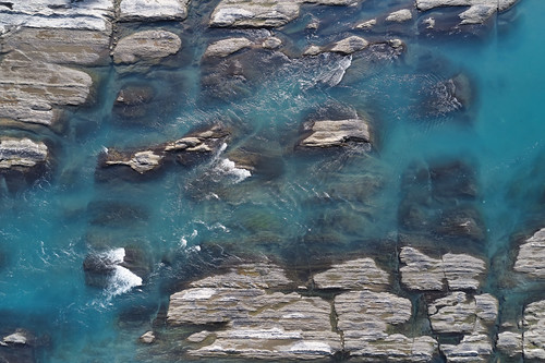 rock texture textural water surface graphic design image river abstract natural nature background backdrop material closeup top view down vertical advertising earth geology blue cool blank copy space copyspace real reality stone wallpaper pattern clear clean