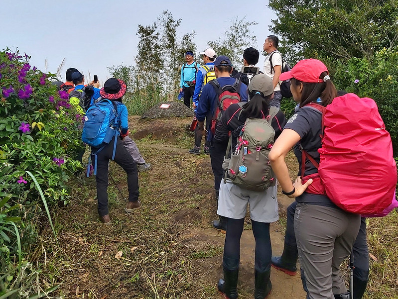 Hikers queueing up to take photos with the Triangulation stone in Taiwan