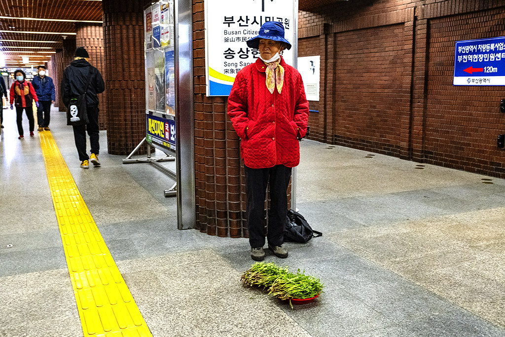 Old woman selling a little bit of leafy vegetable at Bujeon Station--Busan