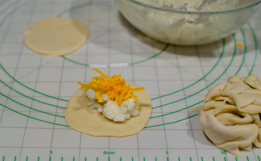 Fill homemade pierogies with mashed potatoes and cheddar cheese.