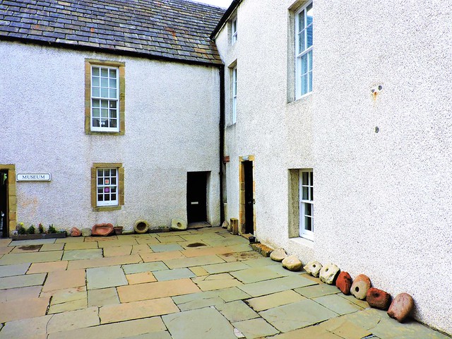 Courtyard, with millstones at perimeter