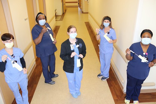 five staff members at East Alabama Medical Center show off the extenders on face masks