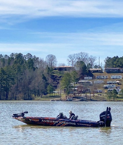A member of Auburn University’s Bass Fishing Club in a boat.
