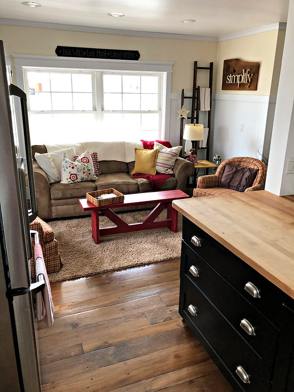 farmhouse living area with red bench and comfortable seating