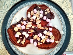 Nutella pancakes with chocolate sauce toasted almonds and marshmallows